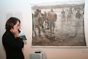Visitor listens to oral history while viewing an archival photo.